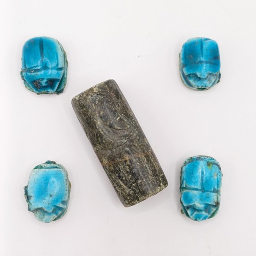 755 - A turquoise glazed Egyptian type scarab, base engraved hieroglyph, three others, and a carved stone ... 