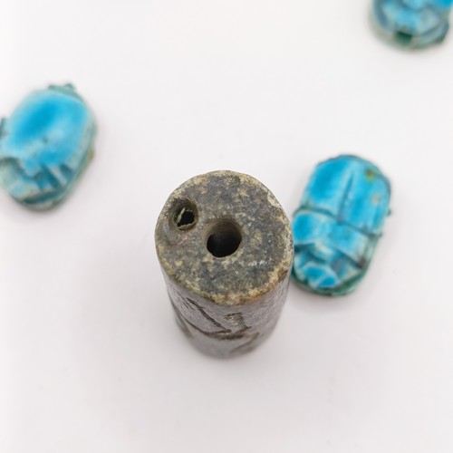 755 - A turquoise glazed Egyptian type scarab, base engraved hieroglyph, three others, and a carved stone ... 