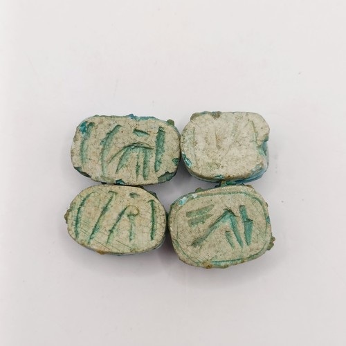 755 - A turquoise glazed Egyptian type scarab, base engraved hieroglyph, three others, and a carved stone ... 