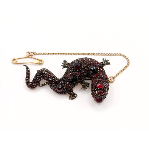 757 - A late 19th/early 20th century yellow metal and garnet lizard brooch