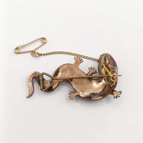 757 - A late 19th/early 20th century yellow metal and garnet lizard brooch