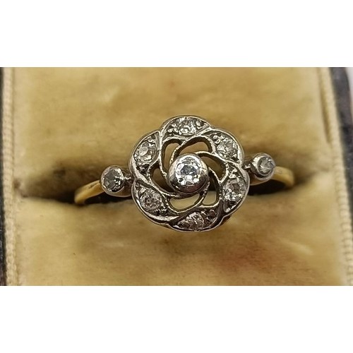 676 - An 18ct gold and diamond daisy ring, ring size U