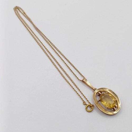 766 - A 9ct gold and yellow stone pendant, with a chain