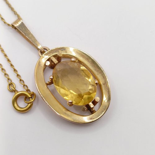 766 - A 9ct gold and yellow stone pendant, with a chain