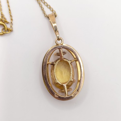 766 - A 9ct gold and yellow stone pendant, with a chain