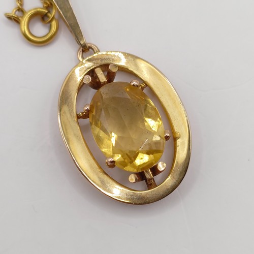 766 - A 9ct gold and yellow stone pendant, with a chain