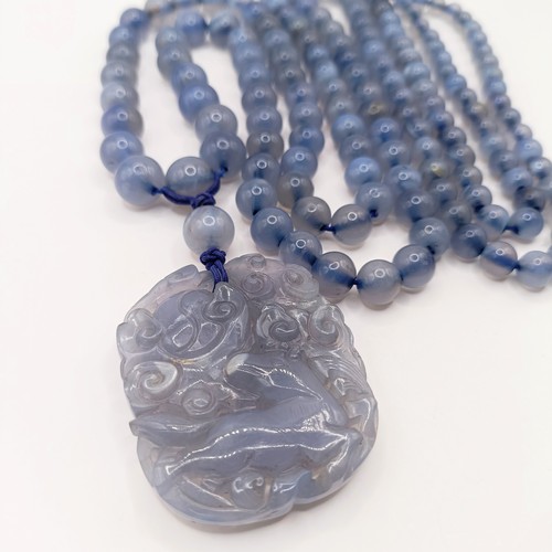 769 - A Chinese carved bead necklace, with pendant decorated animals