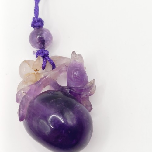 776 - A Chinese amethyst carved pendant, decorated bird and fruit, approx. 45 x 30 mm