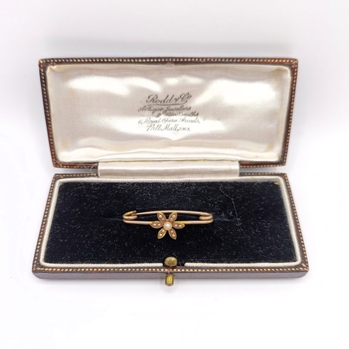 778 - An early 20th century yellow metal and seed pearl bar brooch, in a vintage jewellery box