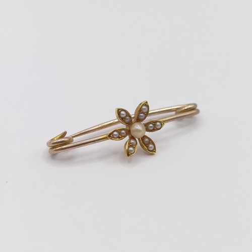 778 - An early 20th century yellow metal and seed pearl bar brooch, in a vintage jewellery box