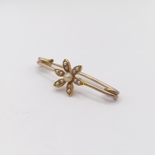 778 - An early 20th century yellow metal and seed pearl bar brooch, in a vintage jewellery box