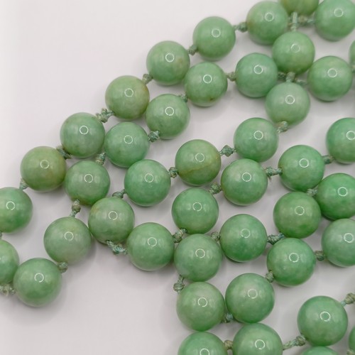 781 - A Chinese green stone bead necklace