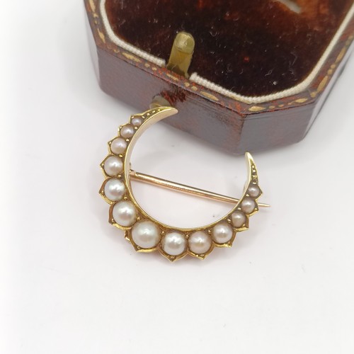 785 - An early 20th century pearl crescent brooch, and a vintage ring box (2)