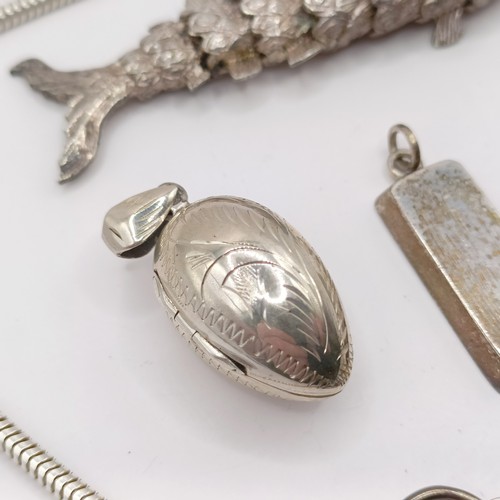 787 - An Eastern silver coloured metal fish pendant, a silver padlock bracelet clasp, a silver and red sto... 