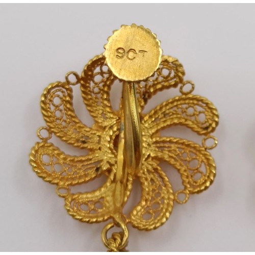 684 - A pair of Indian yellow metal filigree earrings