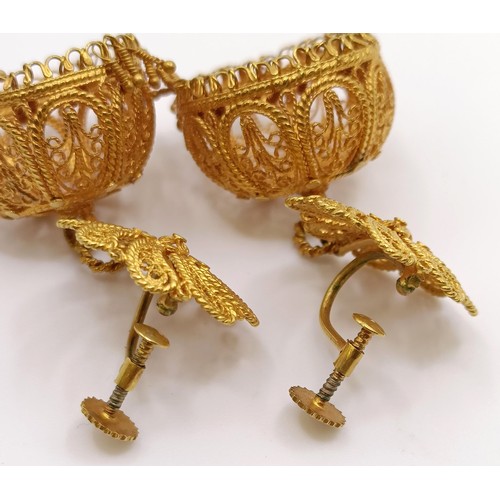 684 - A pair of Indian yellow metal filigree earrings