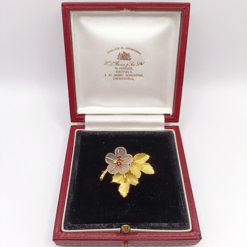 803 - A gold, red white stone and glass flower brooch, boxed