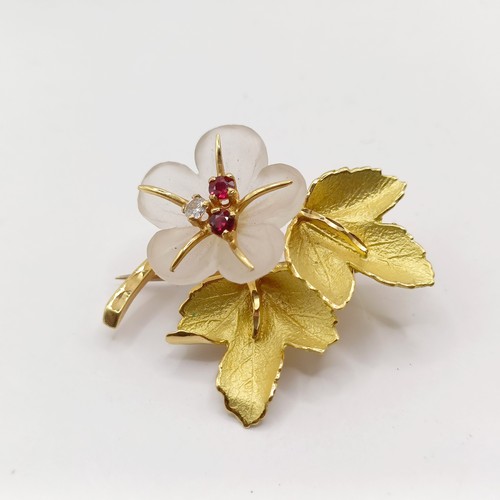 803 - A gold, red white stone and glass flower brooch, boxed