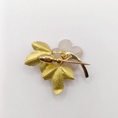 803 - A gold, red white stone and glass flower brooch, boxed