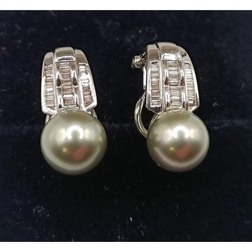 699 - A pair of 18ct white gold and pearl earrings