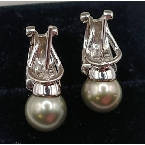 699 - A pair of 18ct white gold and pearl earrings