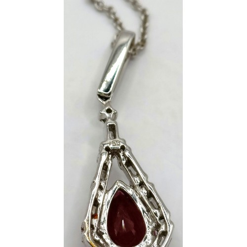 709 - An 18ct white gold, diamond and ruby necklace