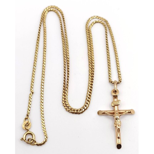 719 - A 9ct gold crucifix, on a chain, 7.1 g