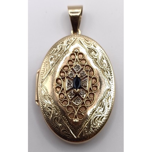 724 - A yellow metal and blue stone oval locket, 7.7 g (all in)