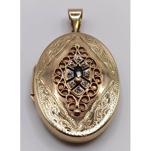 724 - A yellow metal and blue stone oval locket, 7.7 g (all in)