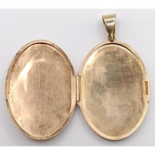 724 - A yellow metal and blue stone oval locket, 7.7 g (all in)