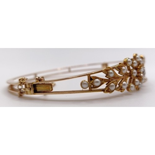 726 - A 15ct gold, seed pearl and diamond bangle, 14.9 g (all in)