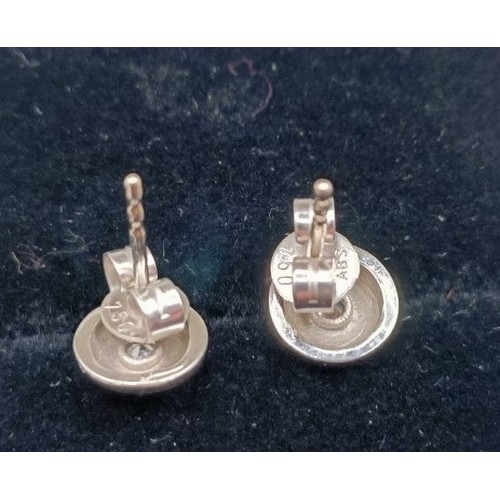 729 - A pair of 18ct white gold and diamond ear studs