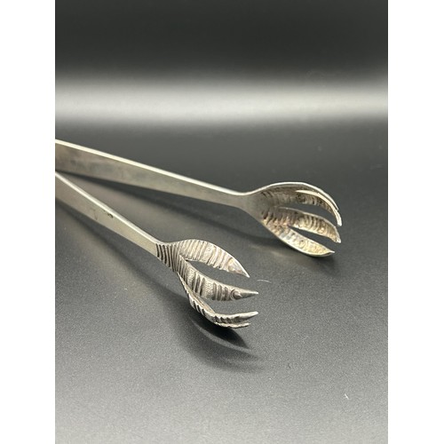 92 - A pair of Chinese silver coloured metal tongs, 1.8 ozt