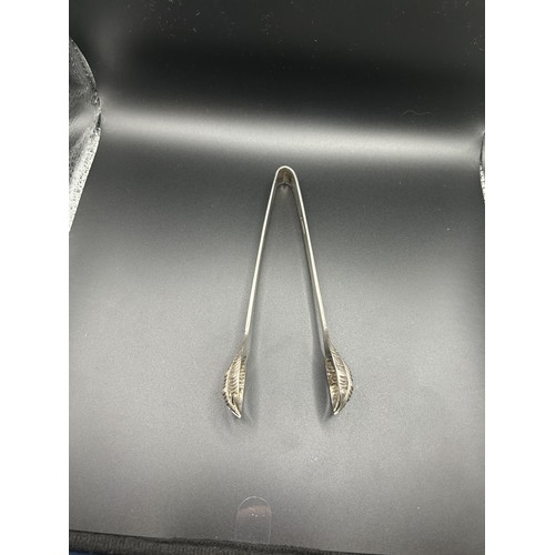 92 - A pair of Chinese silver coloured metal tongs, 1.8 ozt