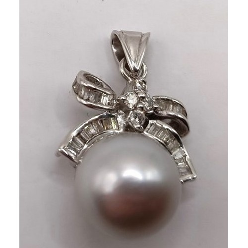 734 - An 18ct white gold, diamond and pearl pendant