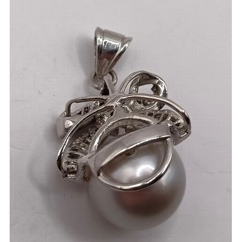 734 - An 18ct white gold, diamond and pearl pendant