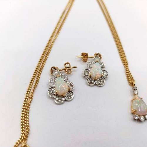 741 - An 18ct gold opal and diamond pendant, on a chain, and a pair of opal earrings