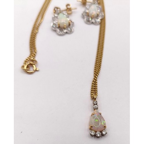 741 - An 18ct gold opal and diamond pendant, on a chain, and a pair of opal earrings