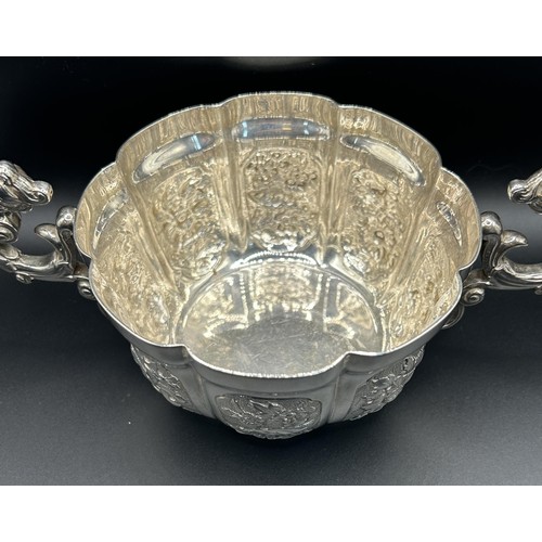 112 - A George V silver bowl, with figural handles, decorated flowers, Carrington & Co, London 1912, 1... 