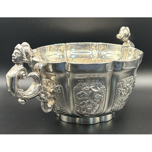 112 - A George V silver bowl, with figural handles, decorated flowers, Carrington & Co, London 1912, 1... 