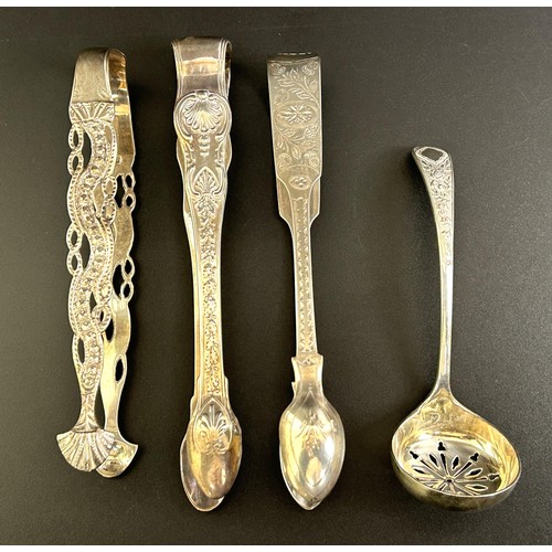 126 - A pair of Victorian sugar tongs, another pair of sugar tongs and a sifting spoon, various dates and ... 