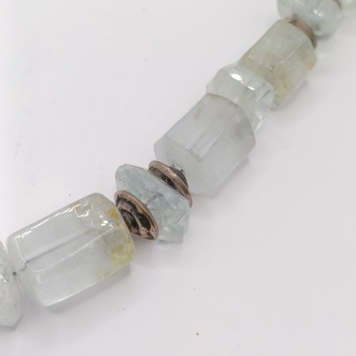 825 - A 20th century aquamarine natural crystal form bead necklace, with silver coloured metal mounts