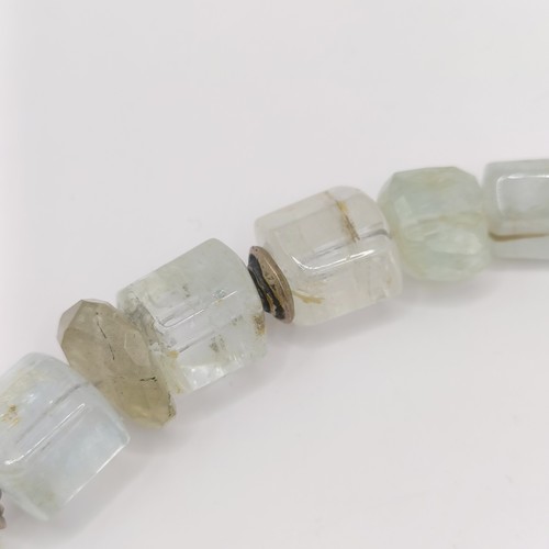 825 - A 20th century aquamarine natural crystal form bead necklace, with silver coloured metal mounts