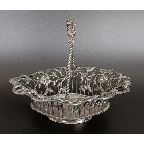 131 - A silver coloured metal swing handled basket, decorated flowers and foliage, initialled, 15 cm wide