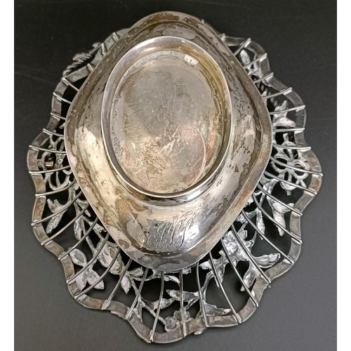 131 - A silver coloured metal swing handled basket, decorated flowers and foliage, initialled, 15 cm wide