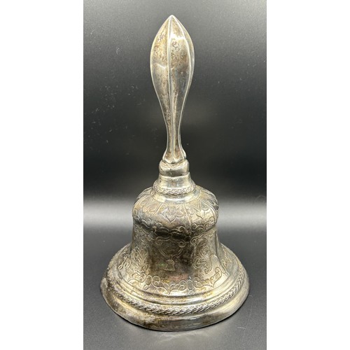 139 - A Dutch silver coloured metal table bell, with engraved decoration, 17 cm high