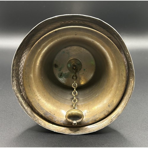 139 - A Dutch silver coloured metal table bell, with engraved decoration, 17 cm high