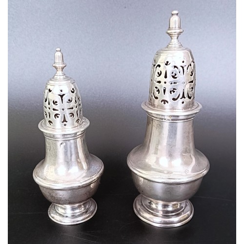 177 - An early 19th century silver caster, marks rubbed, 13 cm high, and another similar, 10 cm high, 6.6 ... 