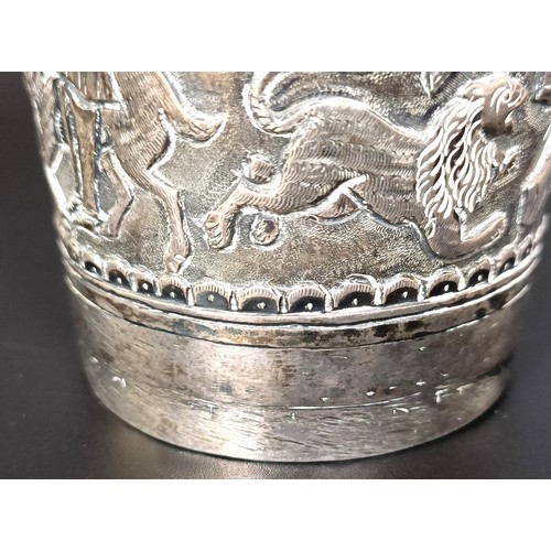 149 - An Indian silver coloured metal beaker, 151 g, a silver plated cocktail shaker, a magnifying glass, ... 