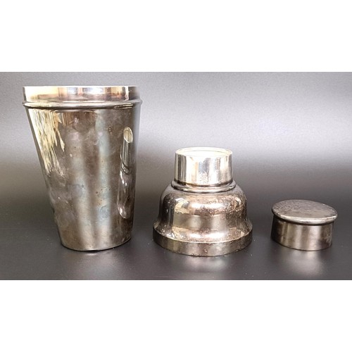 149 - An Indian silver coloured metal beaker, 151 g, a silver plated cocktail shaker, a magnifying glass, ... 